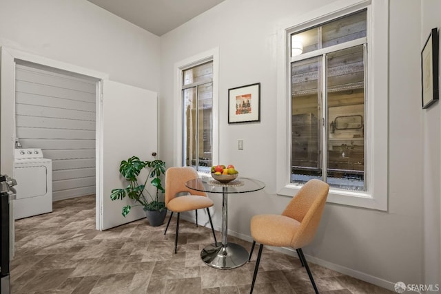 living area featuring washer / dryer and baseboards