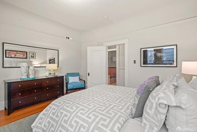 bedroom featuring wood finished floors and visible vents