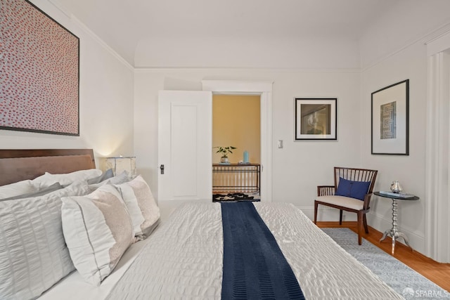 bedroom with baseboards and wood finished floors