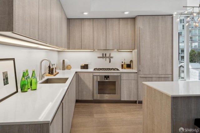 333 Beale St Unit 7G, San Francisco, CA 94105 - kitchen with light brown cabinetry, oven, modern cabinets, and light wood-type flooring