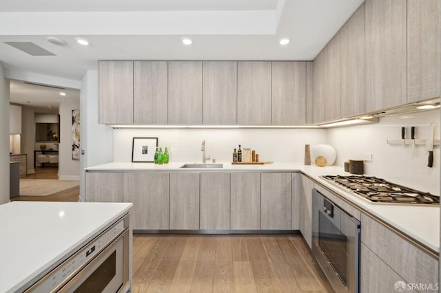 333 Beale St Unit 7G, San Francisco, CA 94105 - kitchen featuring oven, modern cabinets, light wood-type flooring, light countertops, and stainless steel gas stovetop