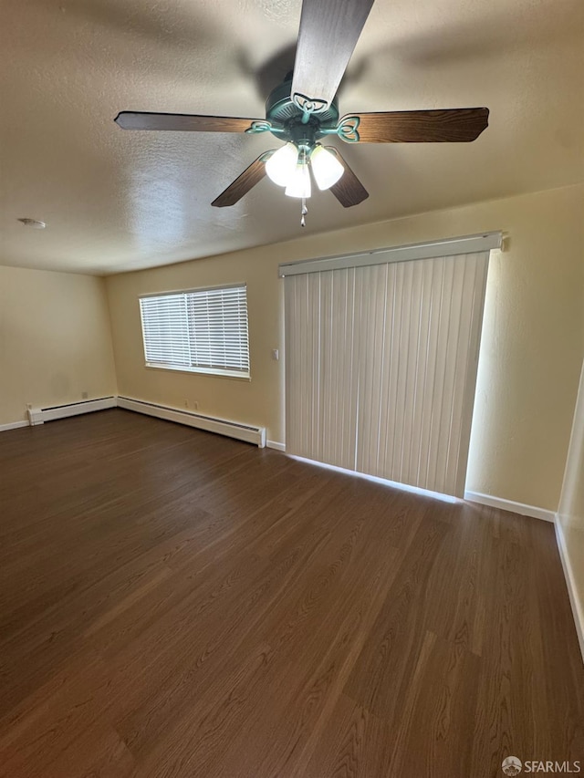 130 Albatross Ct Unit 16, San Francisco, CA 94124 - spare room with dark wood-style floors, baseboards, ceiling fan, a textured ceiling, and baseboard heating