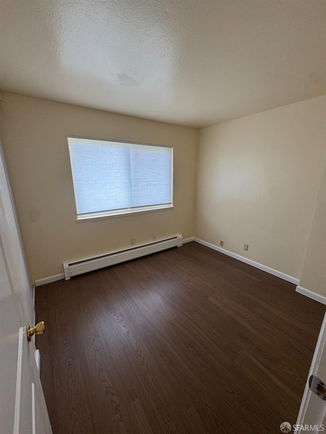 130 Albatross Ct Unit 16, San Francisco, CA 94124 - spare room with a baseboard radiator, dark wood-style flooring, and baseboards