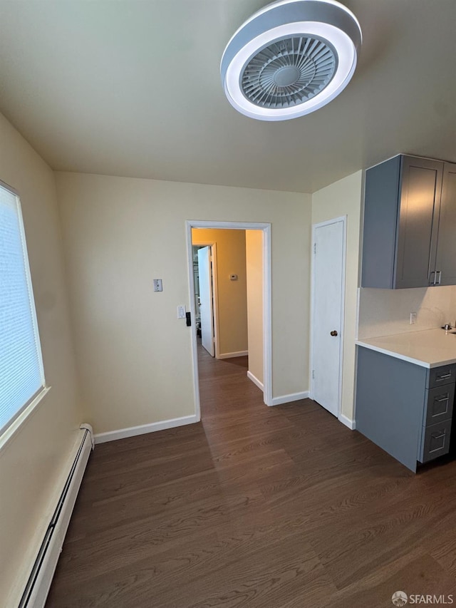 130 Albatross Ct Unit 16, San Francisco, CA 94124 - kitchen with gray cabinets, a baseboard radiator, dark wood-style floors, light countertops, and baseboards