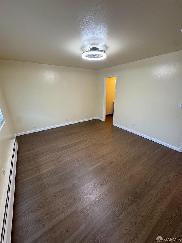 130 Albatross Ct Unit 16, San Francisco, CA 94124 - unfurnished room with dark wood-style floors, a baseboard radiator, and baseboards