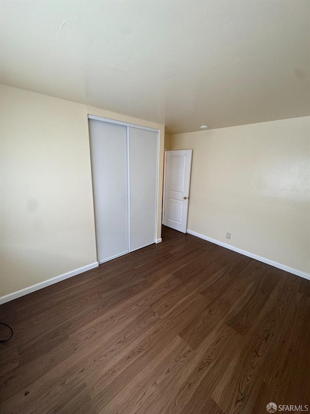 130 Albatross Ct Unit 16, San Francisco, CA 94124 - unfurnished bedroom featuring baseboards, dark wood-type flooring, and a closet