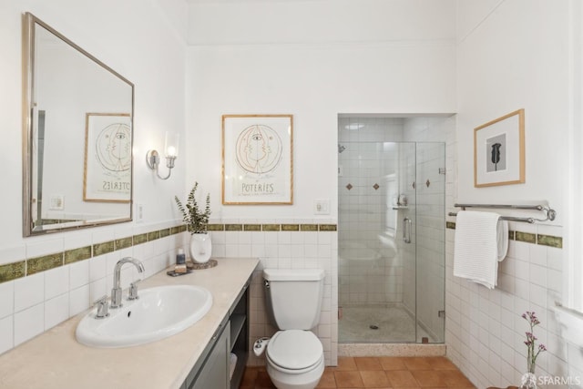 full bath featuring a shower stall, toilet, tile walls, and vanity