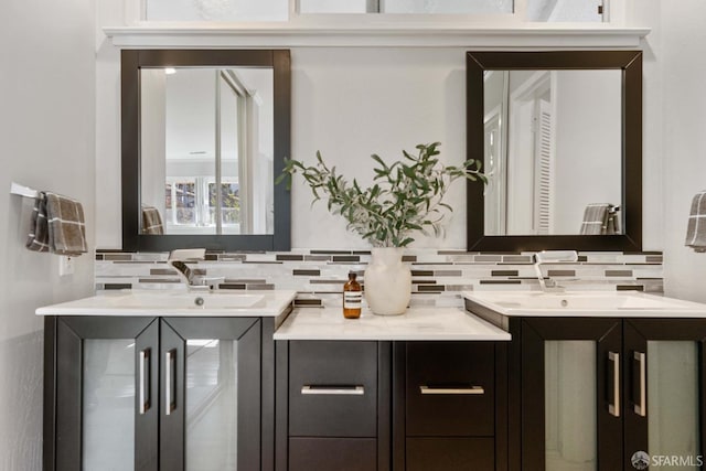 bathroom featuring decorative backsplash and vanity