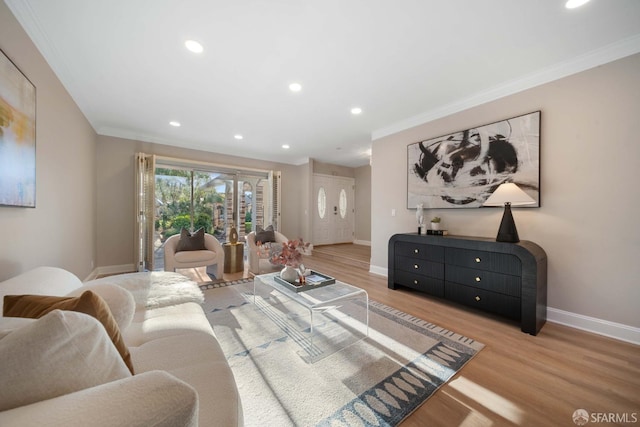 living room with ornamental molding and light hardwood / wood-style floors