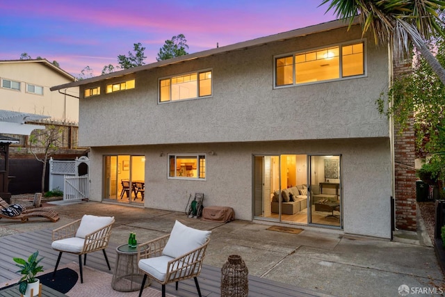 back house at dusk with a patio