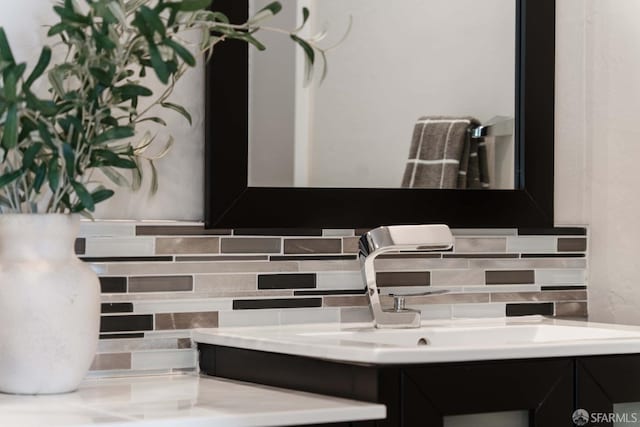 bathroom featuring vanity and decorative backsplash