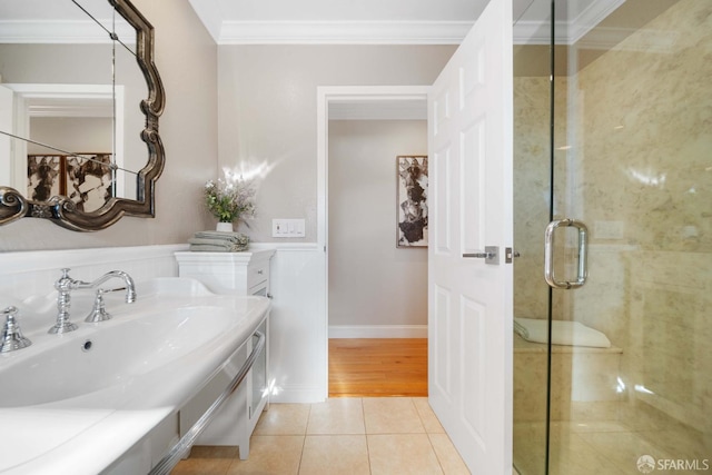 bathroom with sink, ornamental molding, a shower with door, and tile patterned flooring