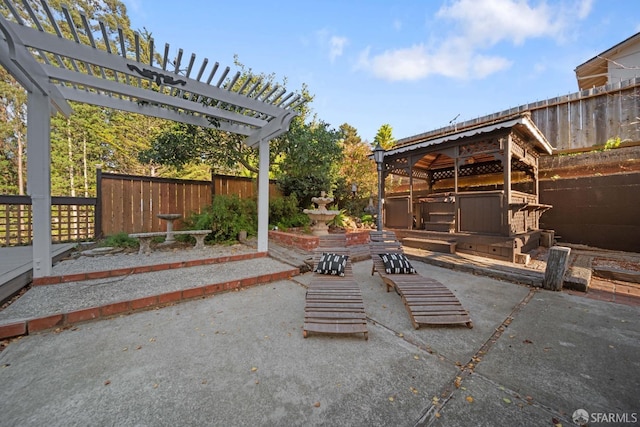 view of patio / terrace with a pergola and a hot tub