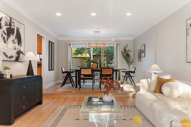 living room with light hardwood / wood-style floors, crown molding, and a chandelier