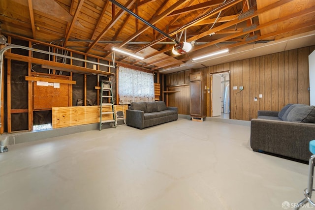 interior space featuring wood walls, concrete flooring, and wooden ceiling