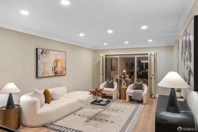 living room with light hardwood / wood-style flooring and crown molding