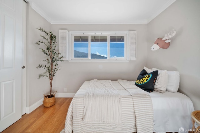 bedroom featuring light hardwood / wood-style floors and ornamental molding