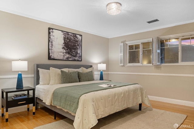 bedroom featuring ornamental molding and wood-type flooring