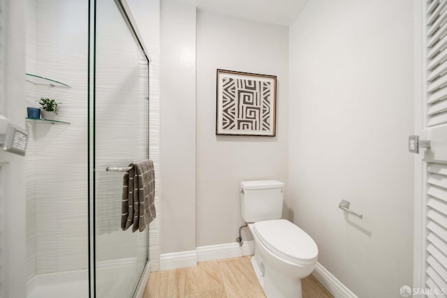 bathroom featuring toilet and an enclosed shower