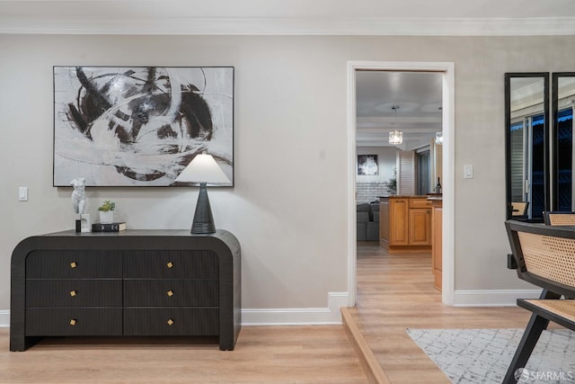 interior space featuring crown molding and light hardwood / wood-style floors