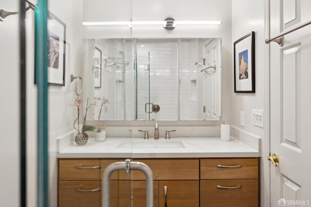 bathroom featuring a shower stall and vanity