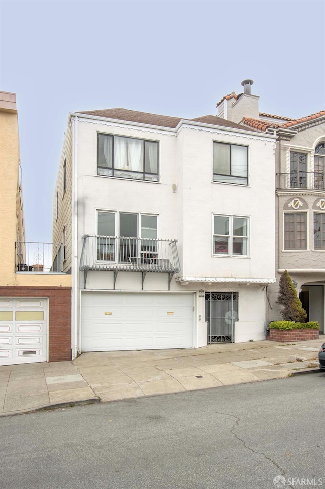 2383-2385 26th Ave, San Francisco, CA 94116 - multi unit property with stucco siding, a garage, a chimney, and concrete driveway