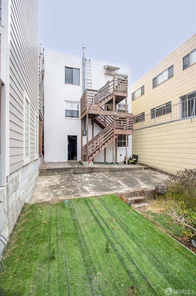 2383-2385 26th Ave, San Francisco, CA 94116 - rear view of house with a patio and a lawn