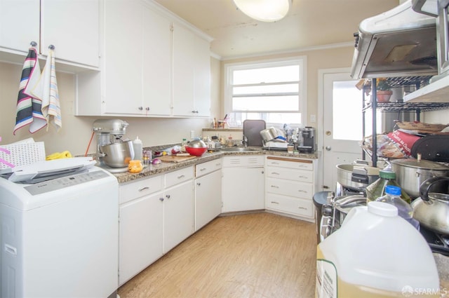2383-2385 26th Ave, San Francisco, CA 94116 - kitchen with washer / dryer, light wood finished floors, ornamental molding, white cabinetry, and light countertops