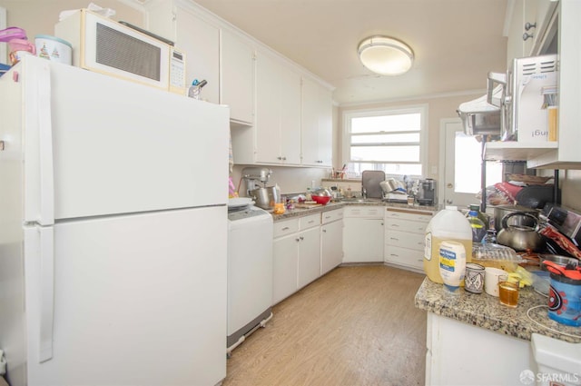 2383-2385 26th Ave, San Francisco, CA 94116 - kitchen featuring freestanding refrigerator, washer / clothes dryer, light wood finished floors, and white cabinetry
