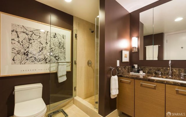 bathroom featuring vanity, toilet, and walk in shower