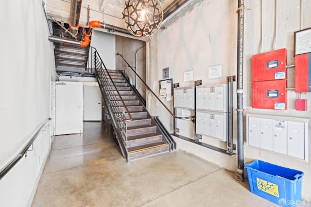 stairway with concrete flooring