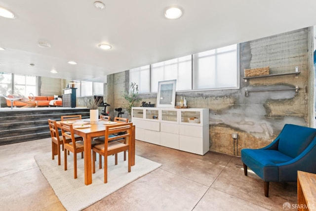 dining area featuring tile walls