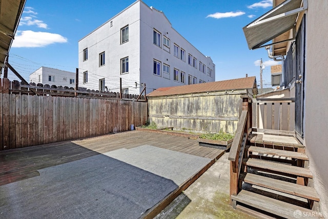 view of patio / terrace featuring a wooden deck and a fenced backyard