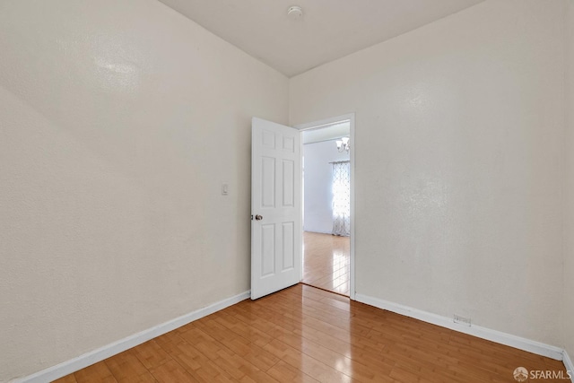 unfurnished room featuring baseboards and light wood-style flooring