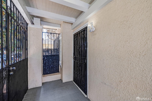 entrance to property featuring stucco siding