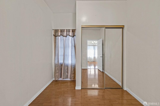interior space with wood finished floors and baseboards