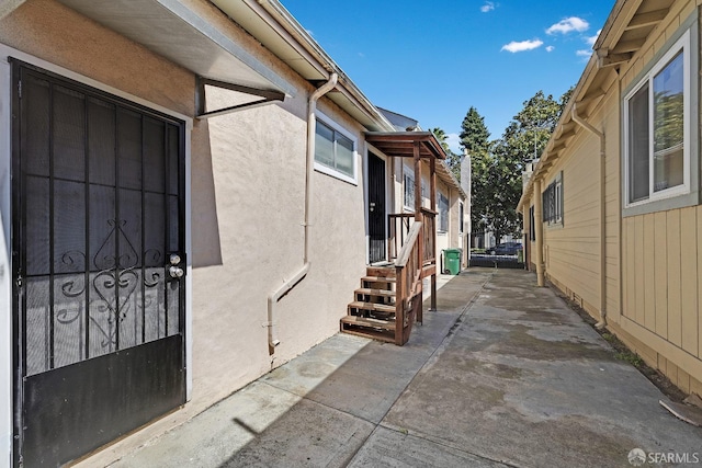 view of side of home featuring a patio and stucco siding