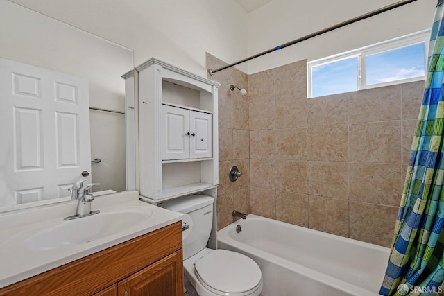 bathroom with shower / tub combo, toilet, and vanity