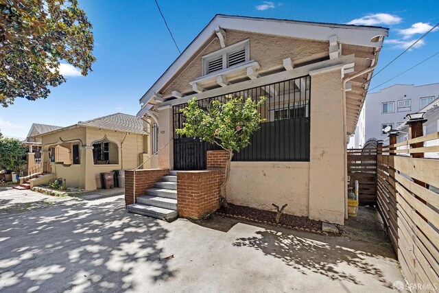 bungalow with a patio area and fence