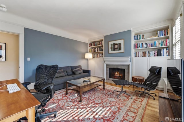 living room with wood-type flooring and built in features