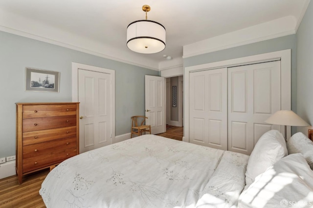 bedroom with crown molding and light hardwood / wood-style floors