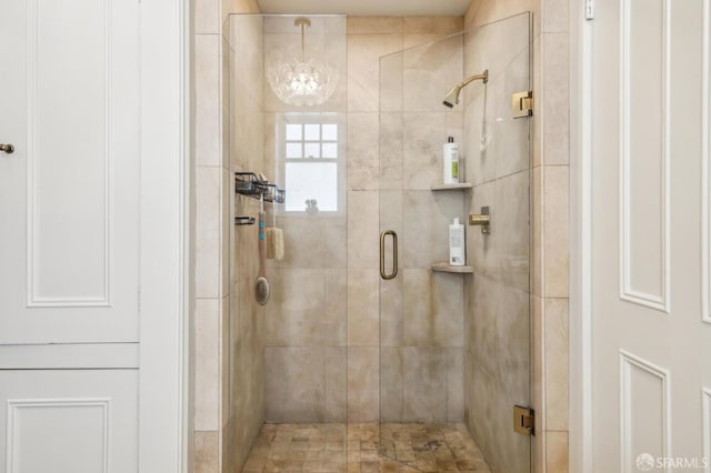 bathroom with a shower with door