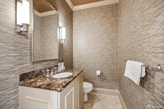 bathroom with vanity, ornamental molding, tile patterned floors, and toilet