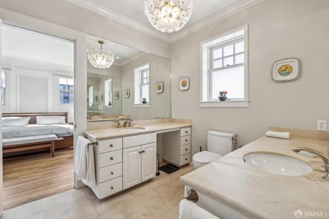 bathroom with tile patterned floors, a healthy amount of sunlight, vanity, and a notable chandelier