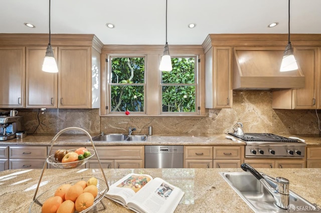 kitchen with pendant lighting, sink, appliances with stainless steel finishes, and premium range hood