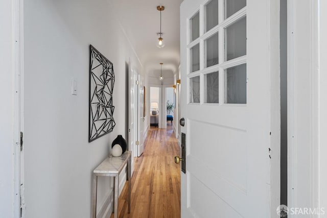 corridor with hardwood / wood-style floors