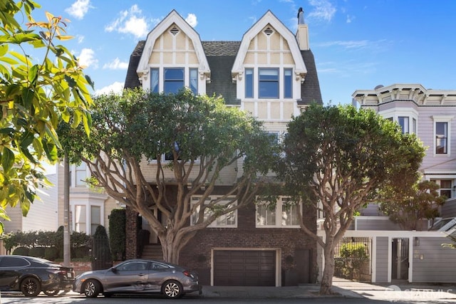 tudor home featuring a garage