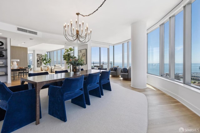 338 Main St Unit Ph36B, San Francisco, CA 94105 - dining area featuring wood finished floors, healthy amount of natural light, a chandelier, and a water view