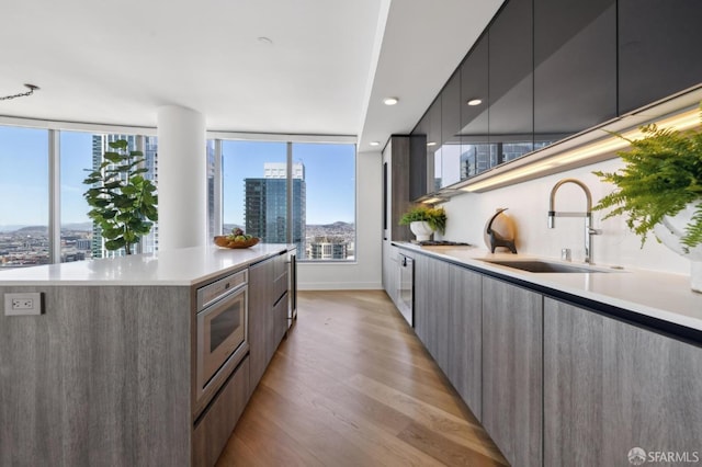 338 Main St Unit Ph36B, San Francisco, CA 94105 - kitchen with modern cabinets, a sink, oven, light wood finished floors, and a city view