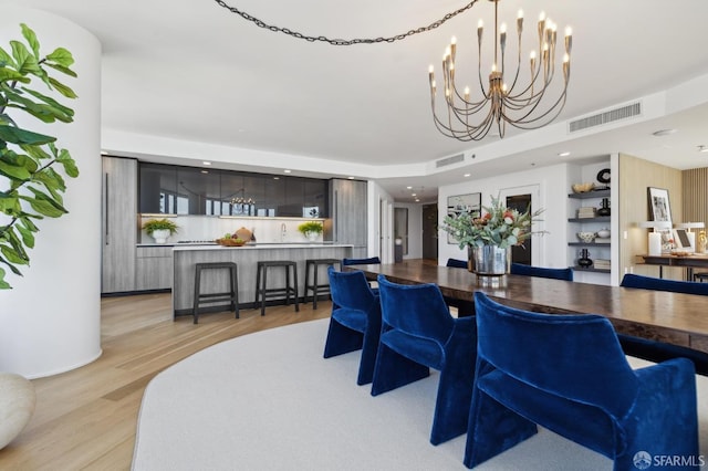 338 Main St Unit Ph36B, San Francisco, CA 94105 - dining area with light wood-style floors, a chandelier, and recessed lighting